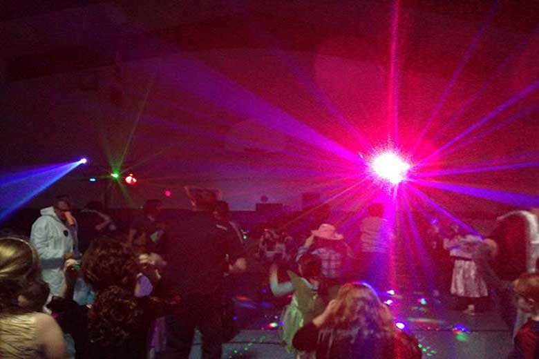 School Light Show Family Dance, DJ Hamilton. Large red beams coming from the light show. Taken in Hamilton Ontario.